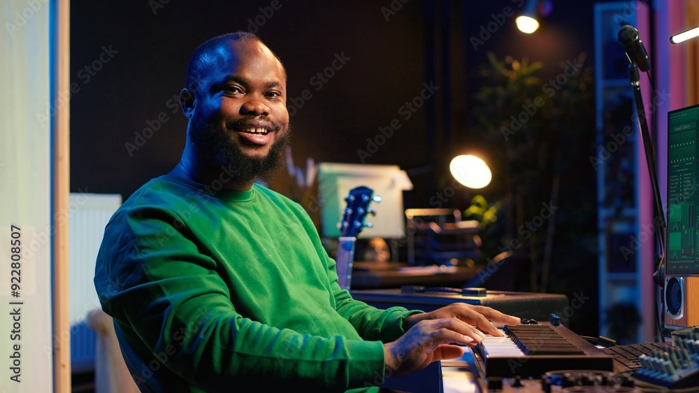 Leinwandbilder skilled music producer creating new songs on midi controller synthesizer, working with mixing consol
