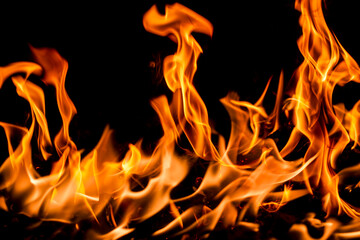 Fire flame background. Hell bonfire. Texture of fire on a black background. Blaze flames background for banner. Burning flames. Fire texture.