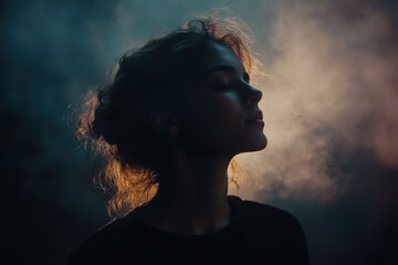 Side profile of a young woman in soft light with a halo effect, creating a dreamy atmosphere