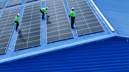 engineer man inspects construction of solar cell panel or photovoltaic cell by electronic device. Industrial Renewable energy of green power. factory worker working on tower roof. © ultramansk