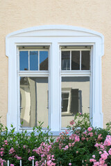 detail of classicistic window at house facade