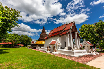 Background of Wat Traphang Thong, which is located in the middle of the water and has a wooden bridge, which is used to organize ceremonies (Loi Krathong, New Year) in Sukhothai province, Thailand.