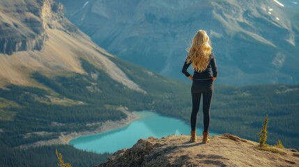 Naklejka premium Woman Standing on Mountaintop Overlooking Valley and Lake