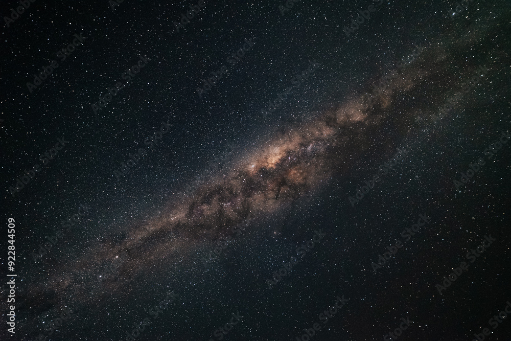 Wall mural the milky way galaxy stretching across a dark starry sky as seen from australia. you can see billion