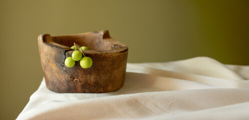 empty vintage wooden tableware on table against green wall for podium backdrop product presentation