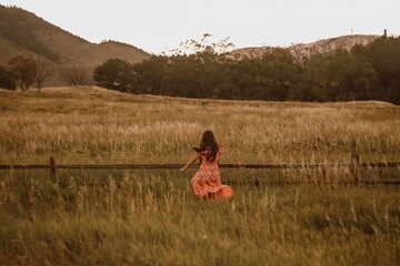 girl running through grassy field