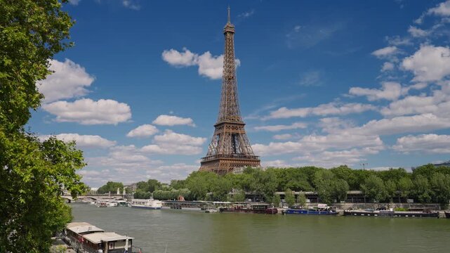 Eiffel tower decorated with Olympic rings for the Olympic games 2024. The Olympic rings installed on the Eiffel Tower with tourists strolling near the Trocadero square