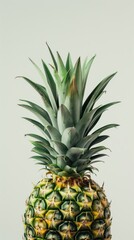 Fototapeta premium A close-up of a pineapple showcasing its textured skin and leafy crown.
