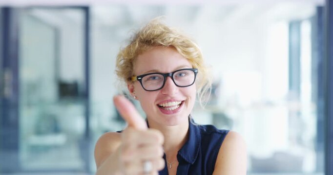 Thumbs up, face and business woman in office for success, winning deal or celebrate achievement. Portrait of happy worker show emoji, like sign and feedback of support, yes or thank you of excellence