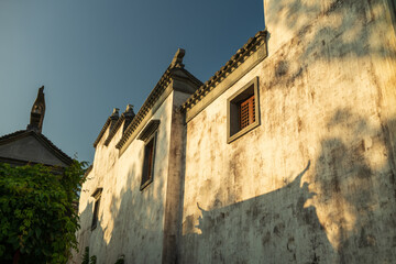 Ancient Chinese buildings and their shadows under the sunset.