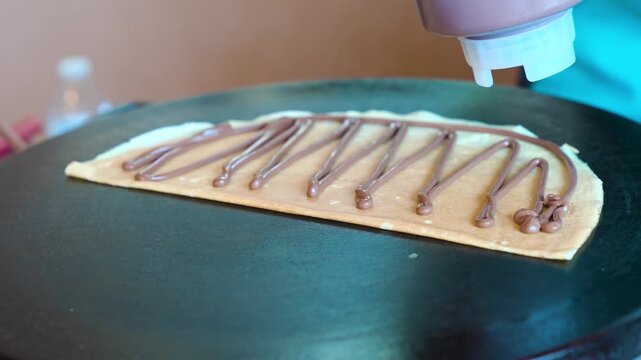 Crepe maker - applying chocolate on crepe