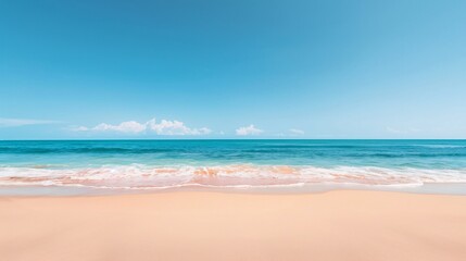 Fototapeta premium Serene beach scene with clear blue skies and gentle waves lapping at the sandy shore.