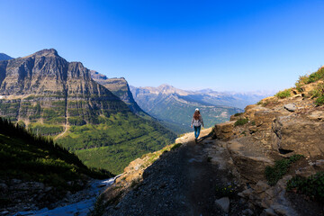 A woman hikes along the Highline Trail in Glacier National Park