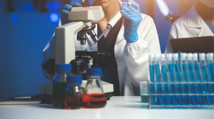 Fototapeta premium professional chemist woman laboratory using scientific microscope for science research, chemistry scientist with microbiology medicals equipment technology to working with medicine biology experiment