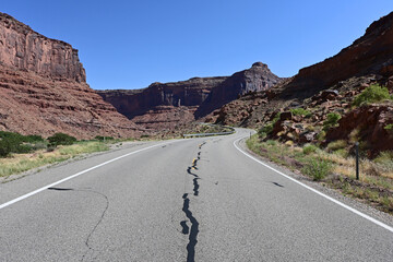 Red rock landscape along Utah State Route 128 near Moab on sunny summer afternoon.