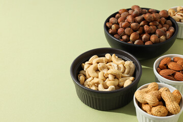 Various nuts in white and black bowls
