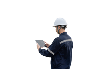 A man wearing a hard hat and a blue shirt is looking at a tablet