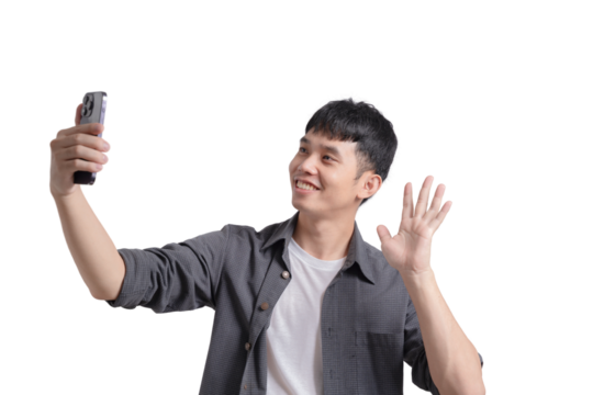 A young man is taking a selfie with his cell phone, smiling