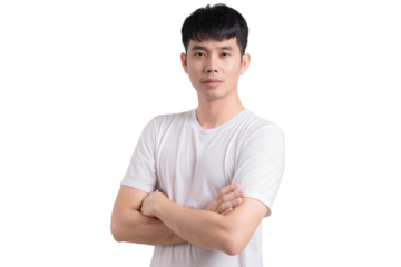 A young man with a white shirt and short hair is standing with his arms crossed