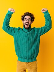 Fototapeta premium Excited man jumping with arms raised in celebration.