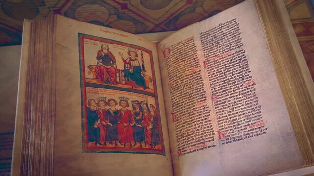 Exquisite medieval Bible manuscript showcased in Hohenzollern Castle, Germany, capturing the essence of historical preservation. Orbit above old manuscript drawings.