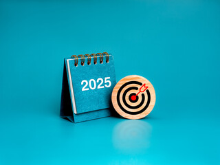 Happy new year 2025 minimal banner. Target icon on round wood block and white 2025 number on blue...