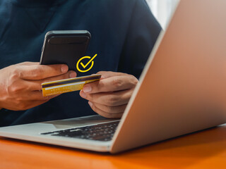 Payment success, financial monthly transaction concepts. Checkmark, payment approved icon in speech bubble appear while businessman using credit card and smartphone for online payment.