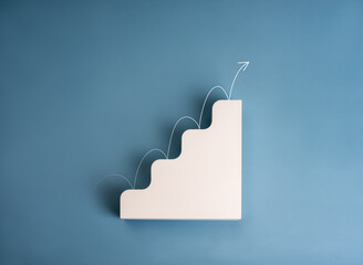 Business growth performance concept. White arrow jumping on modern white geometric stair 4 level steps as growing graph isolated on blue background. Simple 3d progress chart object minimalist design.