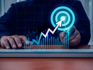 Return on investment - ROI, business success, profit financial  concepts. Arrow up to target icon to big target icon on digital growth graph pointing by businessman hand while working with computer.