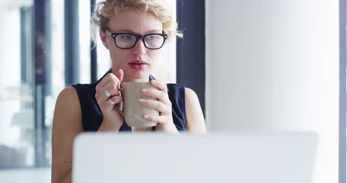 Business woman, laptop or thinking with coffee in office for online ideas, problem solving or future insight. Employee, daydream or drinking cup of tea at computer for energy, inspiration or planning