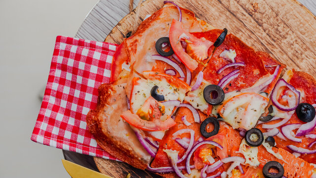 Slice of pepperoni pizza in hand isolated on white. Top view on paperoni pizza. Concept for italian food, street food, fast food, quick bite