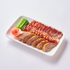 Roast pork and crispy pork with Chinese sausage on a white plate with side vegetables and pickled ginger.