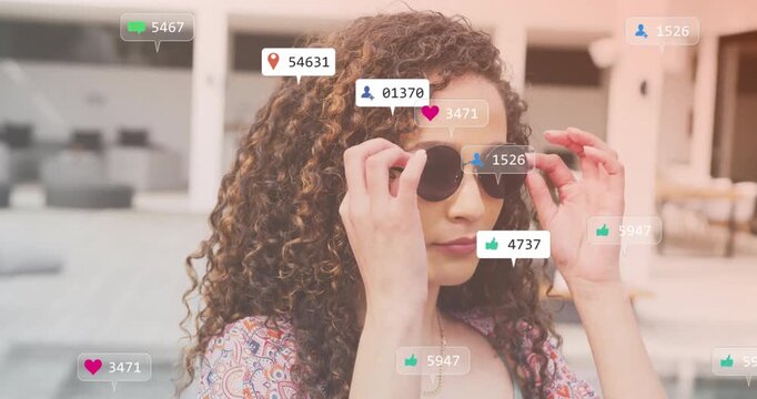 Social media likes and follower counts animation over woman adjusting sunglasses - Powered by Adobe