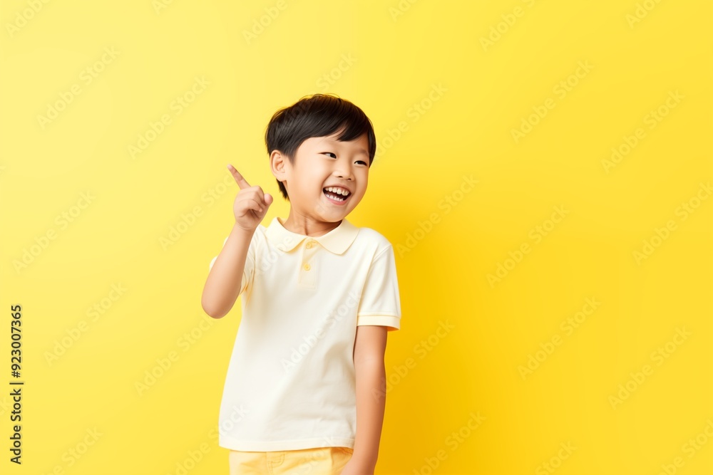 Wall mural cute little asian boy laughing and smiling raise hand