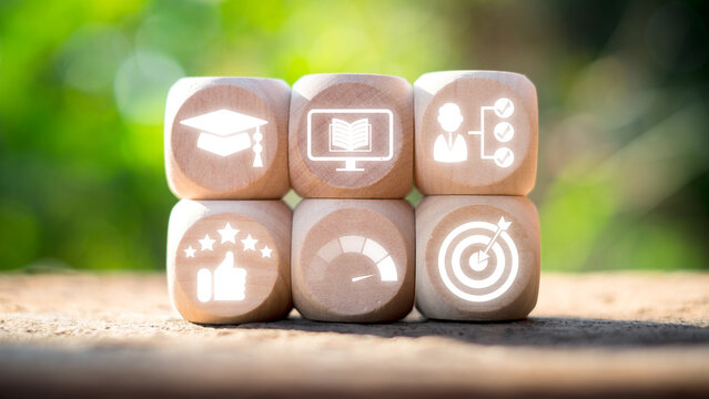 Wooden blocks with icons representing education, training, skill development, and success in an apprenticeship concept.