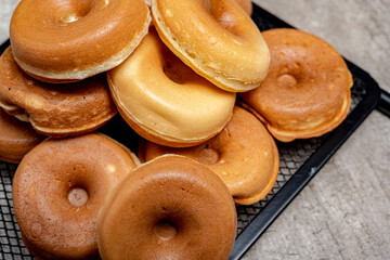A stack of mini donuts on a black tray