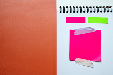 Pink and green sticky notes on a white background