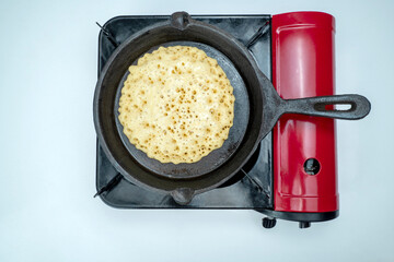 A pan of batter is cooking on a stove
