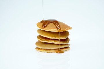 A stack of pancakes with syrup on top