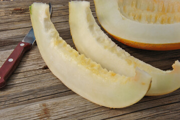 cut juicy ripe melon on wooden table close-up. selective focus