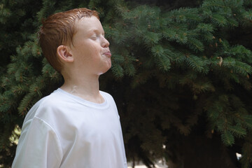 Boy spits water out of his mouth