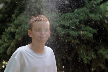Boy spits water out of his mouth