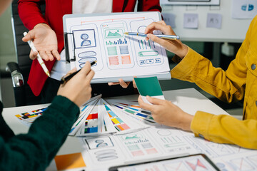  UX developer and ui designer brainstorming about mobile app interface wireframe design with...