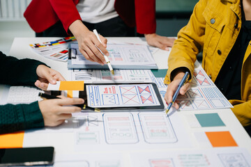  UX developer and ui designer brainstorming about mobile app interface wireframe design with...