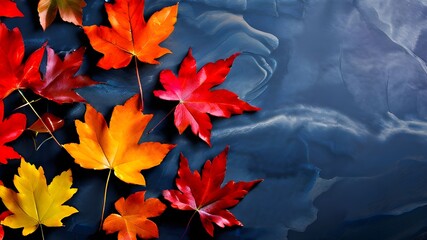 Autumn background with colored red leaves on blue slate background. Top view, copy space, 
