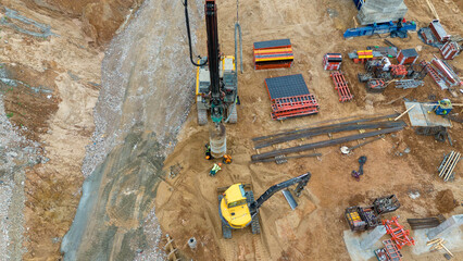 Drone photography of construction drill at construction site during summer day