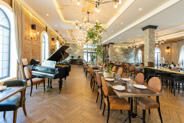 Interior of a modern hotel cafe restaurant with piano