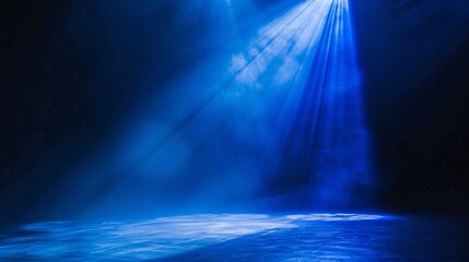 A dynamic azure spotlight casting a striking contrast of brightness and shadow on a dim stage.