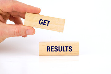 GET RESULTS text written phrase made of wooden blocks is laid out on a white background