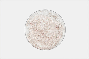 Petri dish with calcium citrate powder on white background, top view